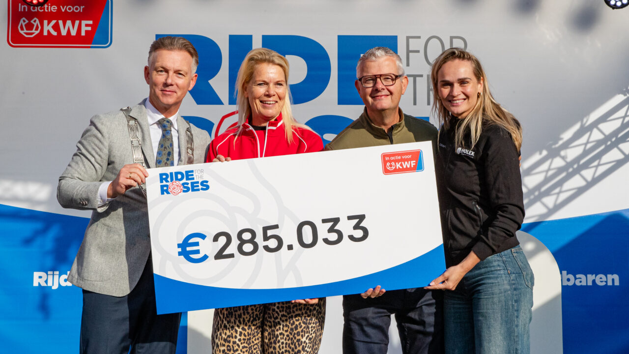 Four people on stage holding a cheque for €285,033, the total raised for KWF during Ride for the Roses 2026.